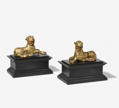 A pair of reclyning lions on bases