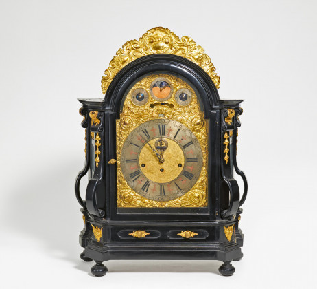 Large ebonized rococo commode clock with gilt appliqués