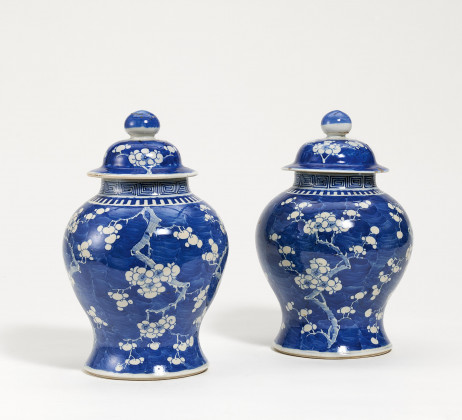 Pair of lidded vases with flowering plums on blue fond