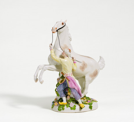 Porcelain figurine of oriental with rearing horse