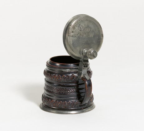 Ceramic and tin tankard with ornamental relief