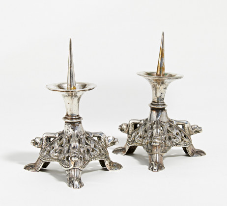 Pair of small romanesque style silver candlesticks
