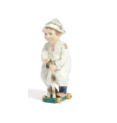 PORCELAIN FIGURINE OF A SMALL BOY WITH WOODEN HORSE