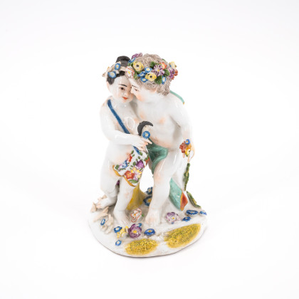 SMALL PORCELAIN PAIR OF AMORETTI WITH ALLEGORICAL ATTRIBUTES OF SPRING AND SUMMER