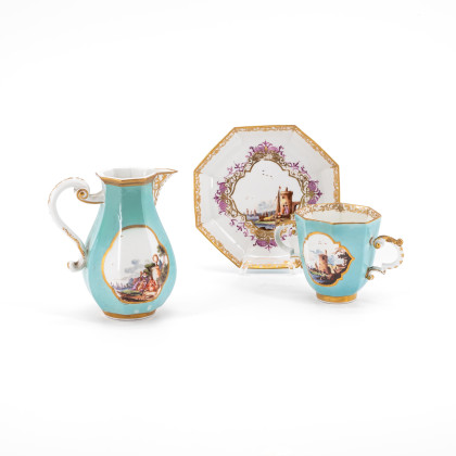OCTAGONAL PORCELAIN CREAM JUG; HANDLES CUP AND SAUCER WITH TURQUOISE BACKGROUND AND LANDSCAPE DECORATIONS