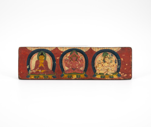 WOODEN PART OF A BOOK COVER WITH COLOURED DEPICTIONS OF THREE DEITIES