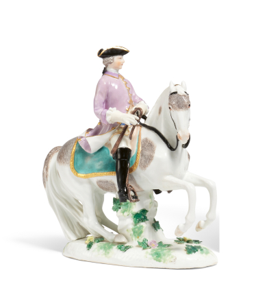 PORCELAIN FIGURINE OF A CAVALIER ON HORSEBACK