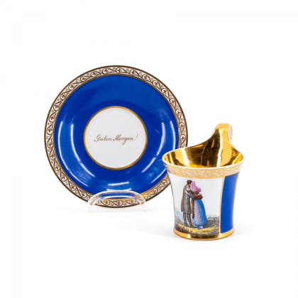 PORCELAIN CUP AND SAUCER WITH AN EMBRACING COUPLE AND APHORISM