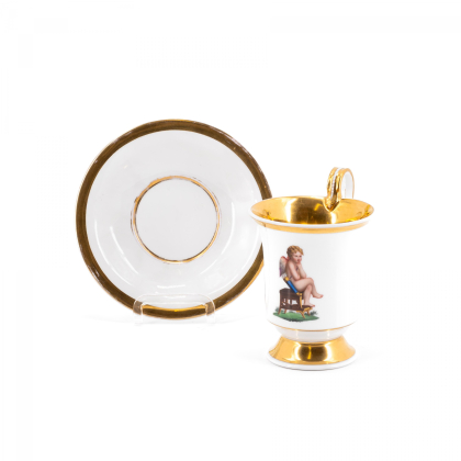 PORCELAIN CUP AND SAUCER WITH BROODING CUPID