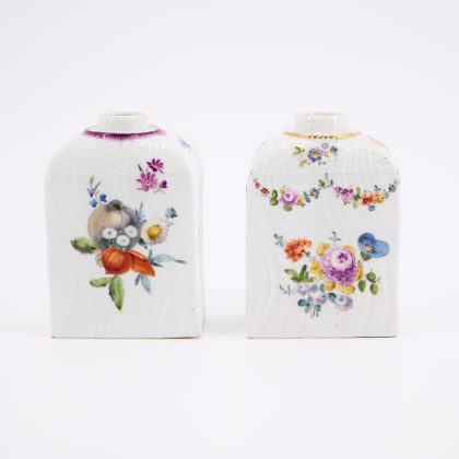 TWO RECTANGULAR PORCELAIN TEA CADDIES WITH TWISTED RELIEF AND FLORAL RESP. FRUIT DECOR