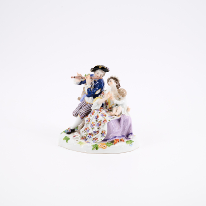 PORCELAIN FIGURINE OF A MUSIC-MAKING SHEPHERD COUPLE WITH CHILD