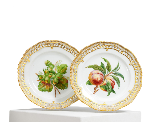 TWO DECORATIVELY PIERCED PORCELAIN DESSERT PLATES WITH FRUIT AND NUTS
