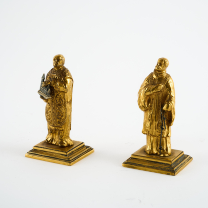 TWO SMALL COPPER FIGURINES OF SAINT FRANCIS AND A SAINT WITH A MODEL OF A CHURCH